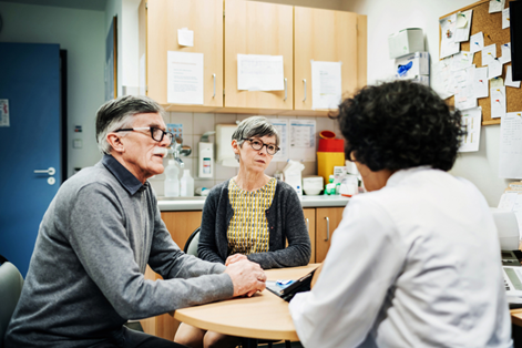 Picture of two people at a table having a discussion with a healthcare provider